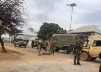 Somali National Army troops and armoured vehicles on a street in Baidoa during Monday's fighting with forces loyal to former president Laftagareen