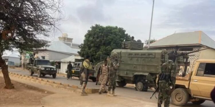 Somali National Army troops and armoured vehicles on a street in Baidoa during Monday's fighting with forces loyal to former president Laftagareen