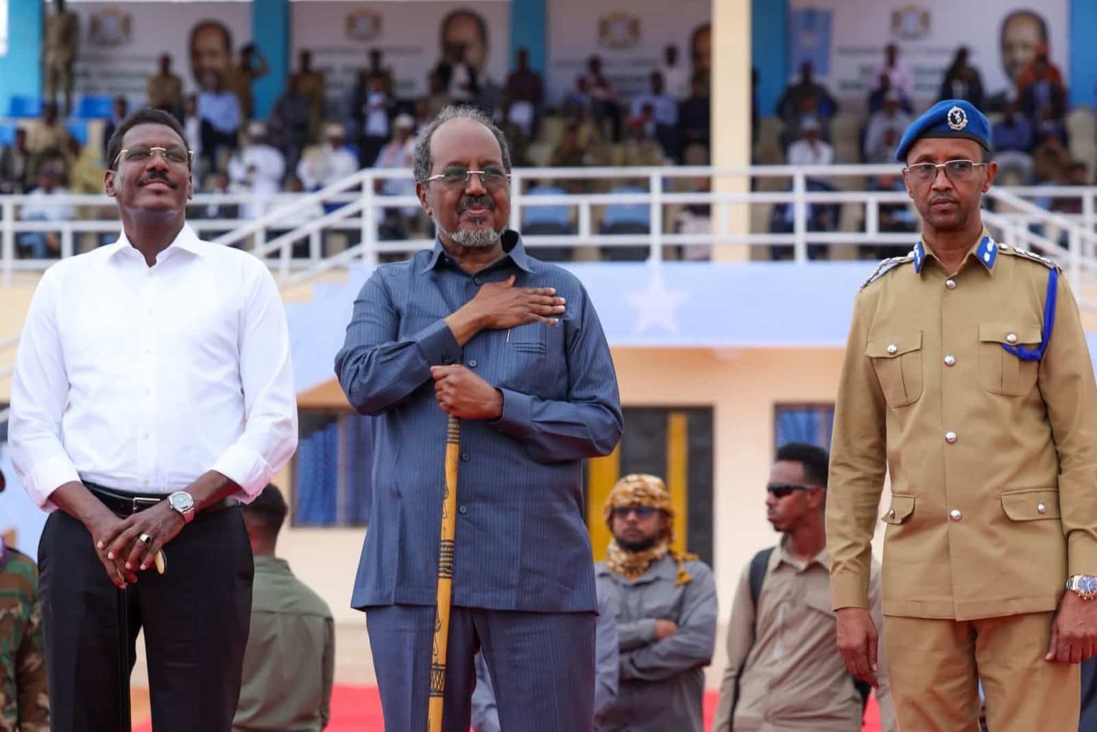 President Hassan Sheikh Mohamud during the anthem at the stadium rally in Baraxleey, with the stand behind him