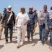 President Said Abdullahi Deni walking through deep sand with officials, elders and Puntland security during his tour of eastern Mudug