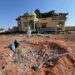 The wrecked compound in Doolow, its roof torn open and a crater in the yard, after the air strike of 4 September 2026